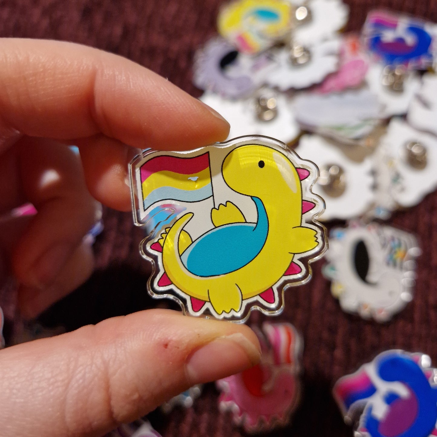 Damaged LGBTQ+ Dino Pins